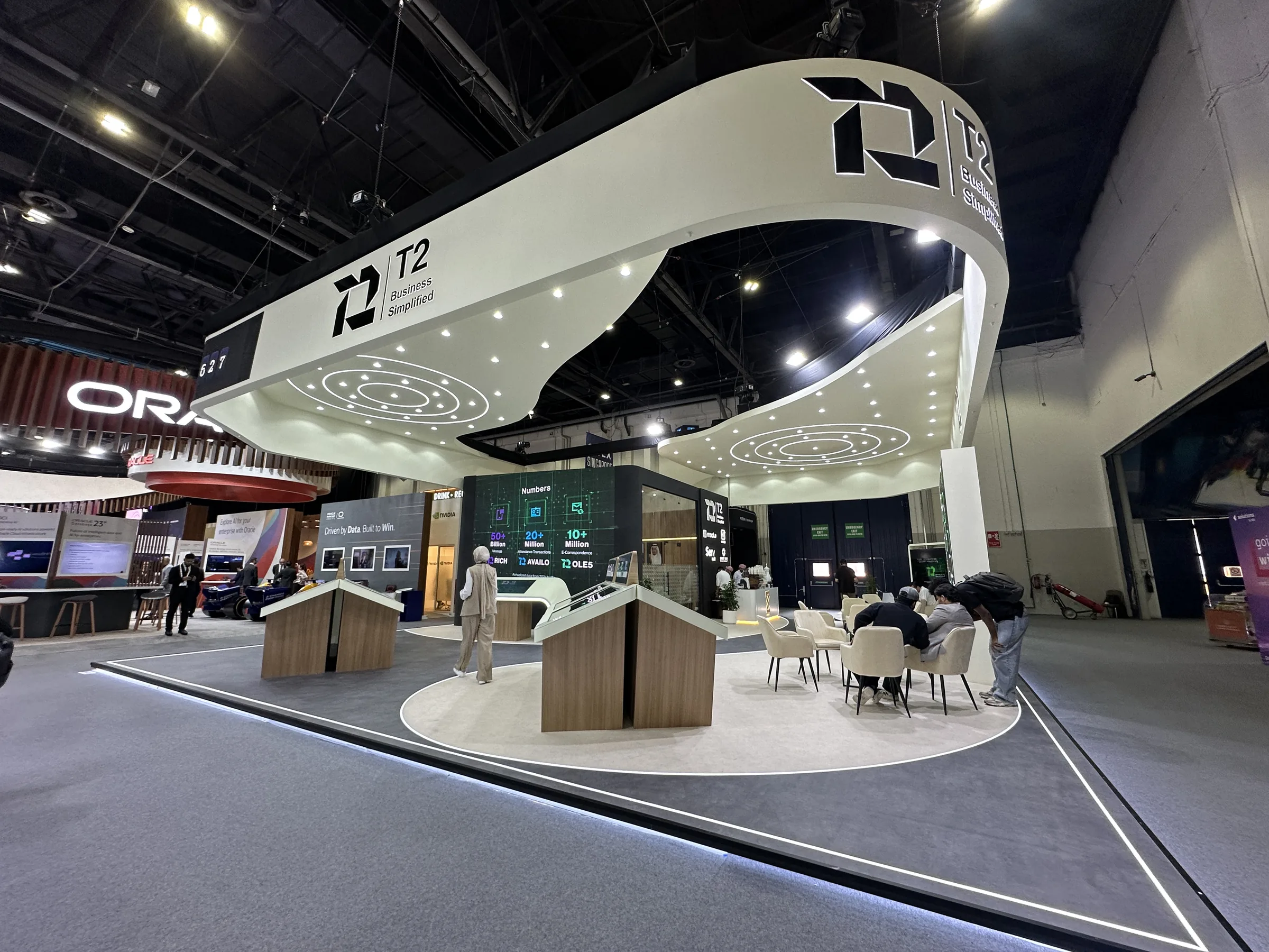 Visitors exploring the T2 Post exhibition stand
