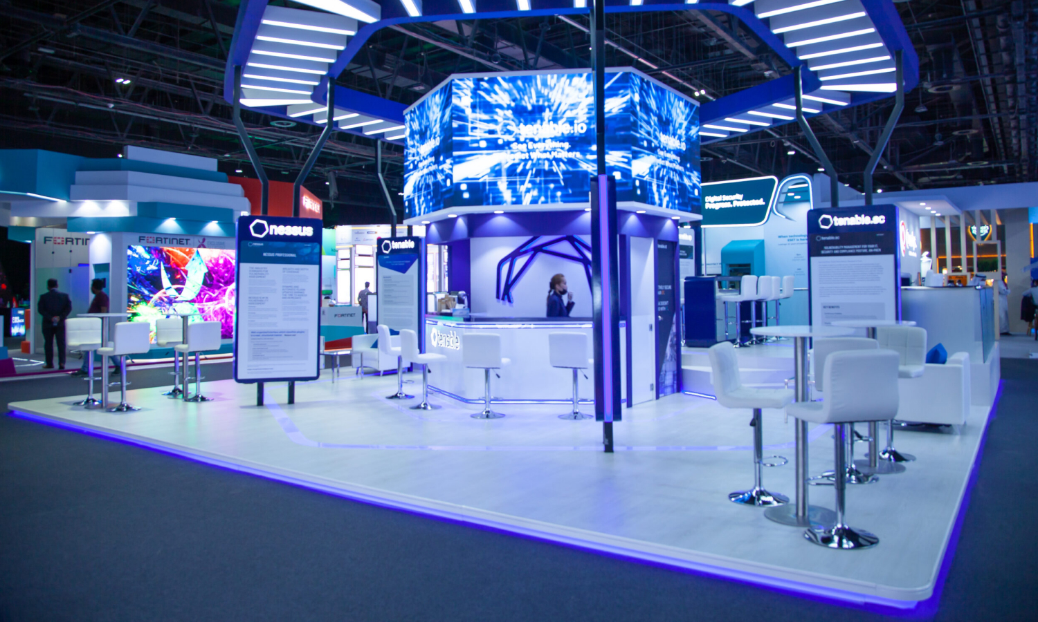 Business professionals discussing solutions at a modern exhibition stand